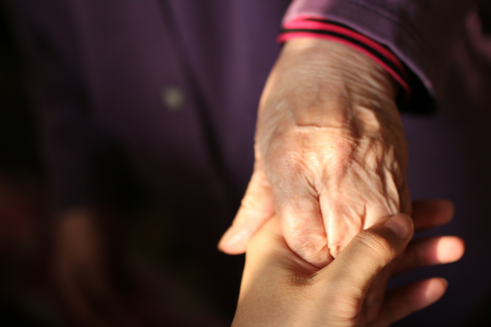 Photo by Hunt Han person in red long sleeve shirt holding hands